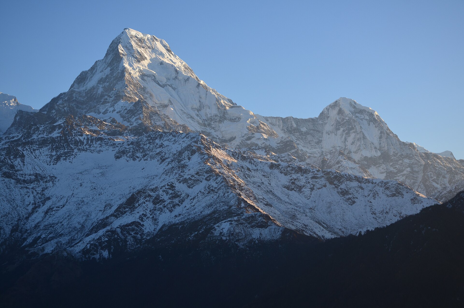 Mist clearing over a Himalayan ridge at dawn